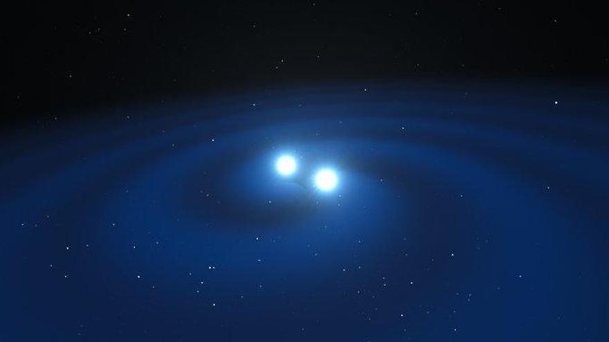 Recreación artística de dos estrellas diminutas pero muy densas de neutrones en el punto en que se fusionan y emiten ondas gravitacionales.