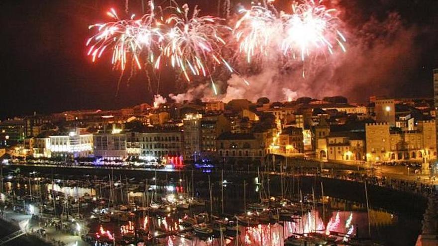 Los fuegos artificiales iluminan Cimadevilla y el puerto deportivo con sus colores. / marcos león