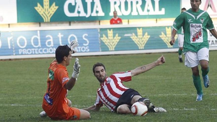 Iker Torre se lanza con todo al suelo en un balón dividido con el meta del CD Guijuelo.