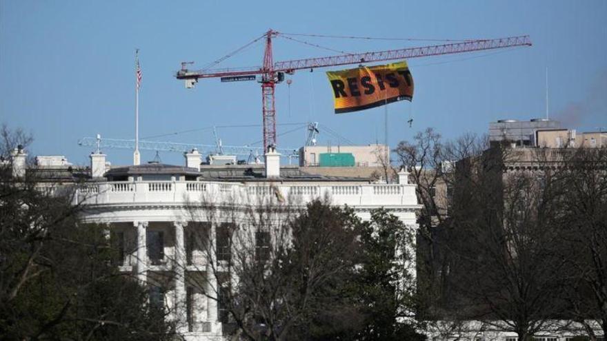 Activistas de Greenpeace cuelgan una pancarta con la palabra &quot;resist&quot; cerca de la Casa Blanca