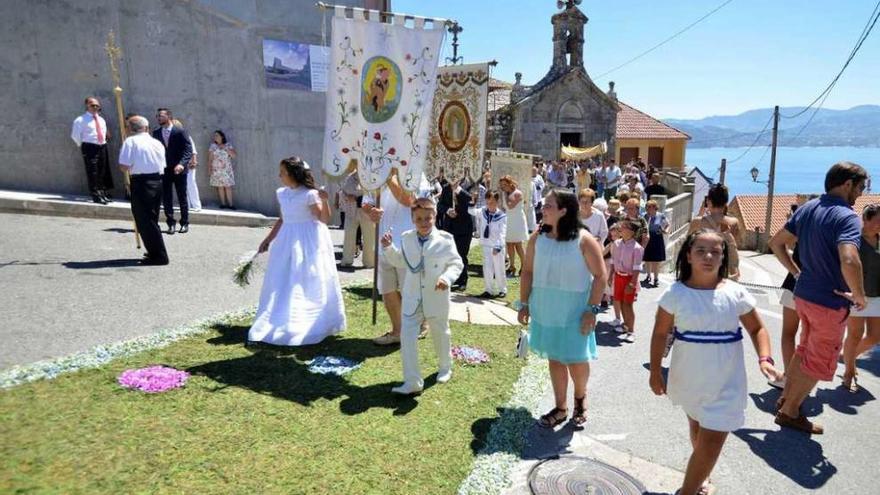 Los fieles de Raxó salen de la Iglesia en la procesión del Corpus. // G. Santos