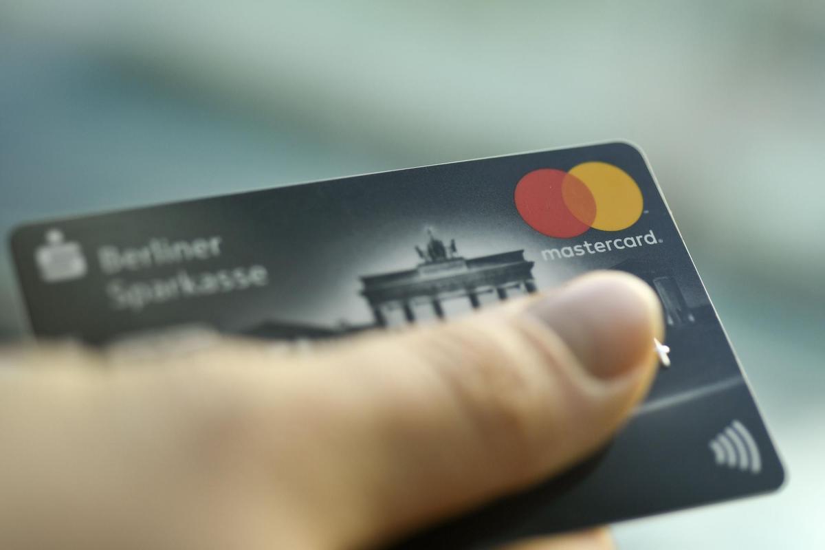 Archivo - Una persona sostiene una tarjeta de crédito de Mastercard.