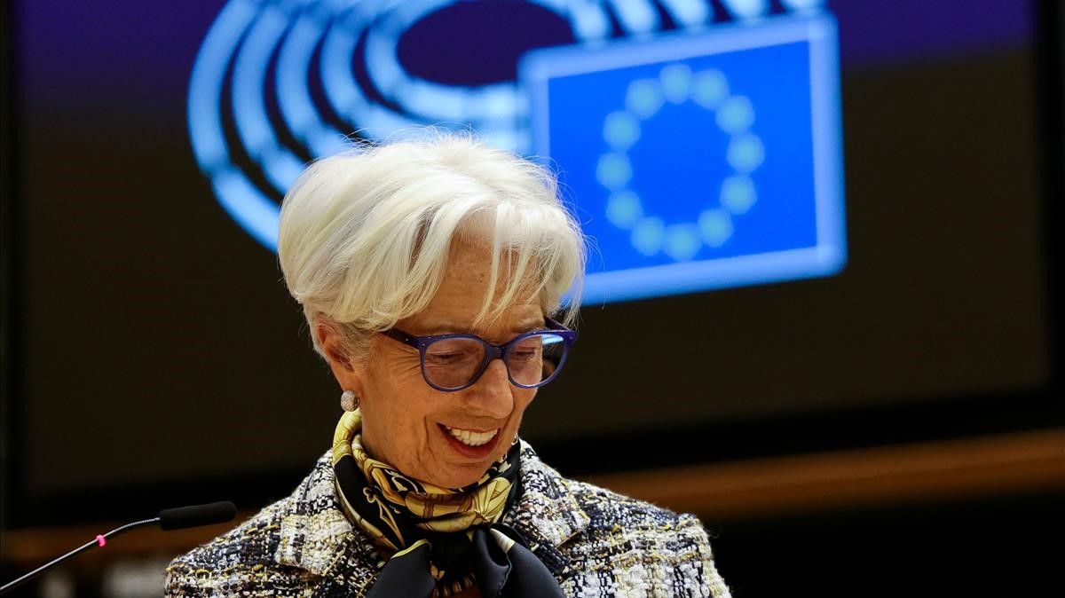 European Central Bank President Christine Lagarde smiles as she addresses European lawmakers during a plenary session at the European Parliament in Brussels  on February 8  2021  (Photo by Olivier Matthys   POOL   AFP)
