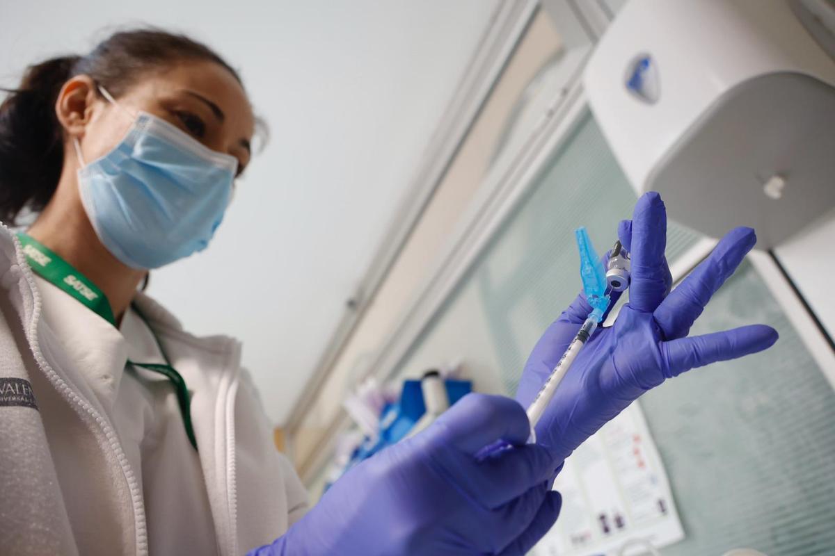 Personal sanitario se encarga de introducir la dosis de la vacuna en la jeringuilla.
