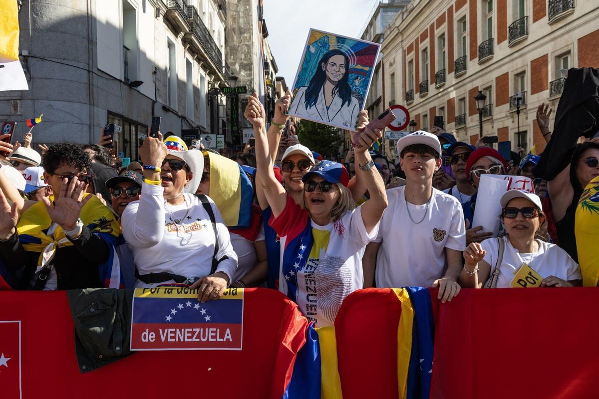 Supporters of Maria Corina Machado, Venezuela's opposition leader, not pictured, cheer during an event in Madrid, Spain, on Saturday, April 18, 2026. Machado said she's "coordinating" her return to the country with the US, without giving a date. Photographer: Claudia Paparelli/Bloomberg