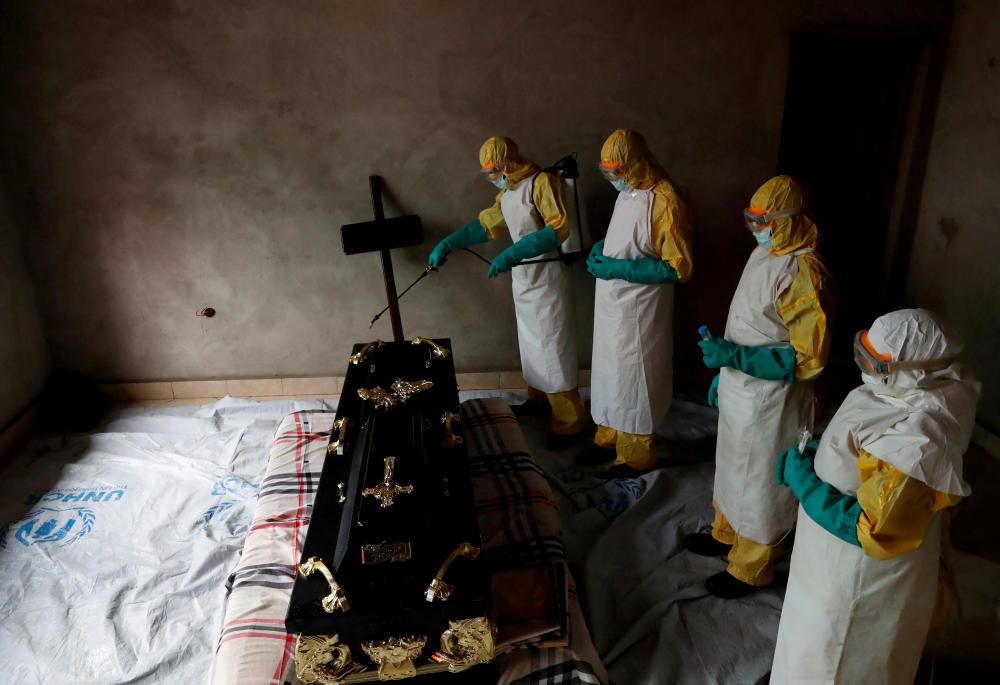 A healthcare worker sprays a room during a ...