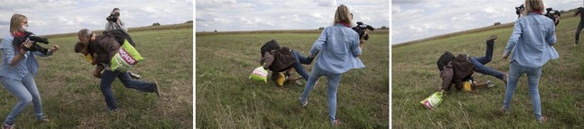 Petra Laszlo fa la traveta a un pare que porta a coll el seu fill i una bossa amb les seves pertinences, a Roszke (Hongria).