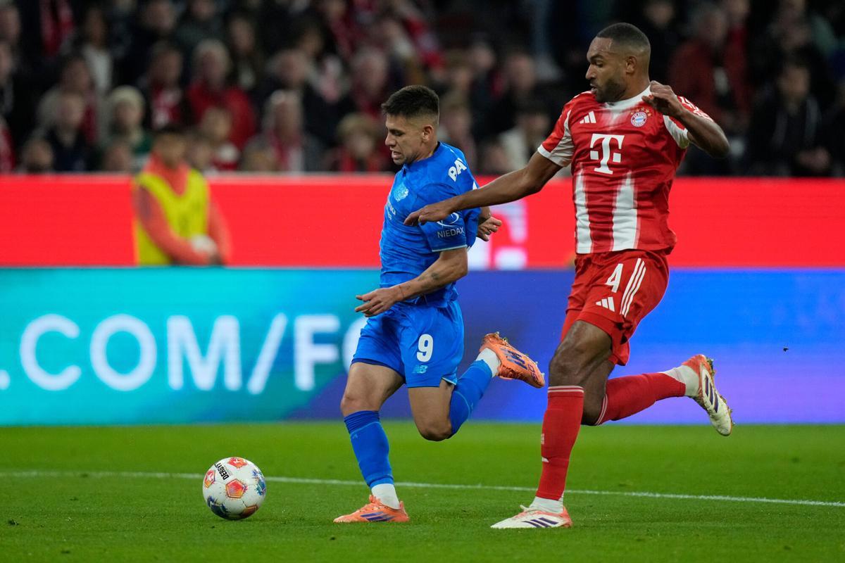Leverkusen's Claudio Echeverri, left, is challenged by Bayern's Jonathan Tah during the German Bundesliga soccer match between Bayern Munich and Bayern Leverkusen in Munich, Germany, Saturday, Nov. 1, 2025. (AP Photo/Matthias Schrader)