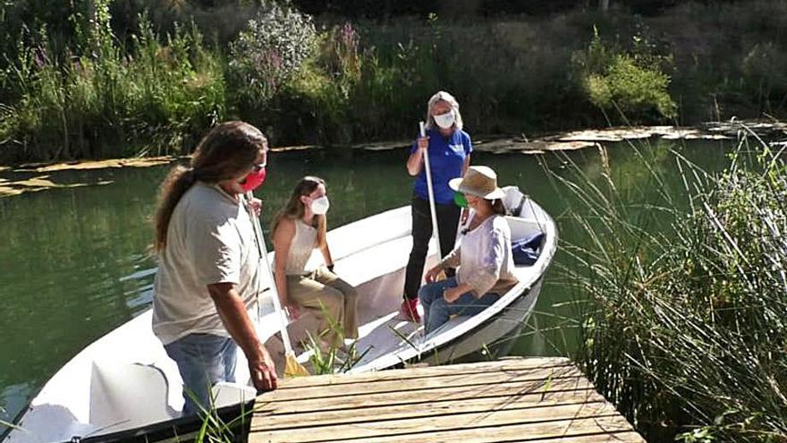 Loles García y Claudia Arrufat recorren en barca el paraje del Clot de Burriana.