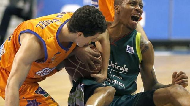 El alero estadounidense del Unicaja lucha el balón con Rodrigo San Miguel.