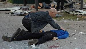 Russias attack on Ukraine continues, in Kharkiv SENSITIVE MATERIAL. THIS IMAGE MAY OFFEND OR DISTURB A man checks the body of his 13 year-old son, who was killed by a Russian military strike, as Russias attack on Ukraine continues, in Kharkiv, Ukraine July 20, 2022. REUTERS/Sofiia Gatilova  SMOUT