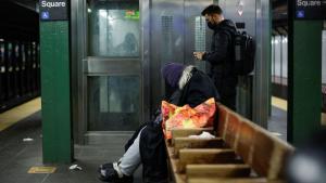 A homeless sleeps inside the subway station in New York