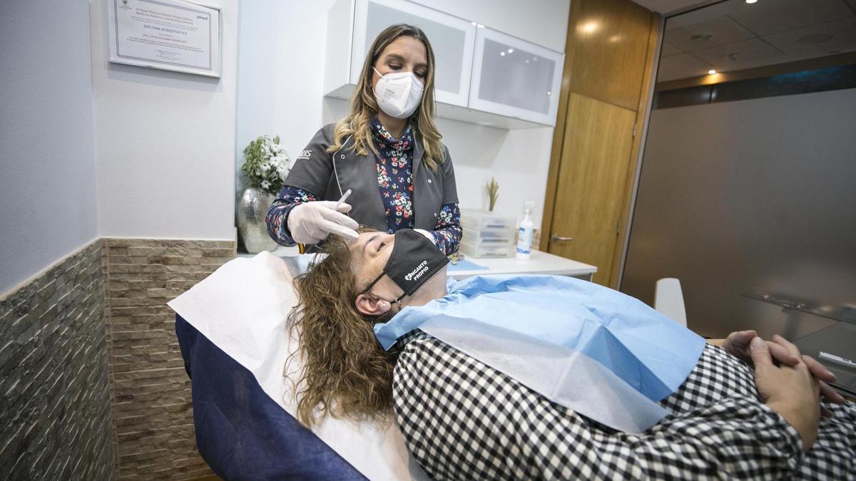 Un momento de la intervención, ayer, en un centro de estética ovetense, con la avilesina María José García en primer término