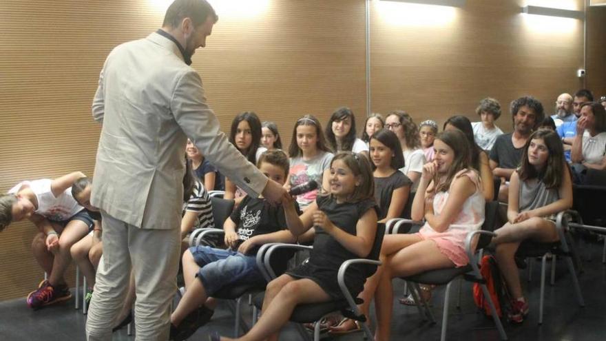 David Colado ofrece el micrófono a una de las niñas que ayer participaron en la charla.