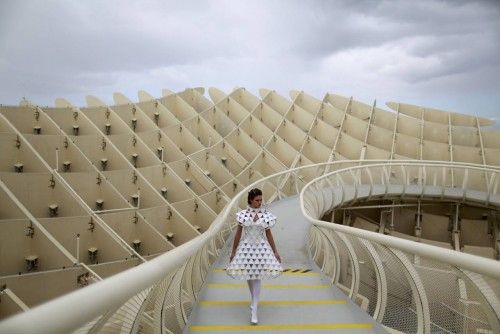 Spanish model, Raquel Bonilla, 22, walks along the footbridge of the wooden structure Metropol Parasol during an urban photo shooting, part of the Andalucia de Moda in Seville