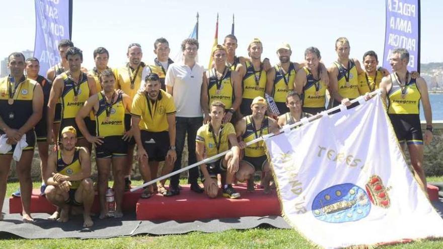 El equipo de Amegrove sostiene la bandera Teresa Herrera tras la disputa de la prueba.