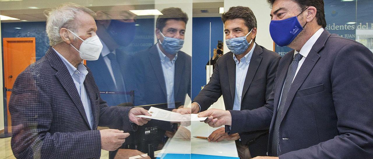 El presidente del Puerto, Juan Antonio Gisbert, recibe del presidente de la Diputación, Carlos Mazón, y el alcalde Luis Barcala, un borrador con las líneas maestras del palacio.