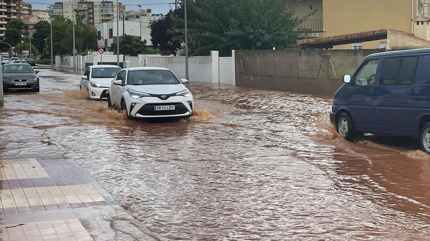 Coches intentan avanzar en las calles inundadas de Benicàssim