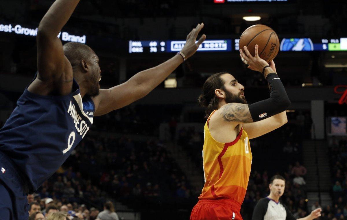 Minnesota Timberwolves’ Luol Deng, left, looms in as Utah Jazz’s Ricky Rubio, of Spain, shoots in the first half of an NBA basketball game Sunday, Jan. 27, 2019, in Minneapolis. (AP Photo/Jim Mone)