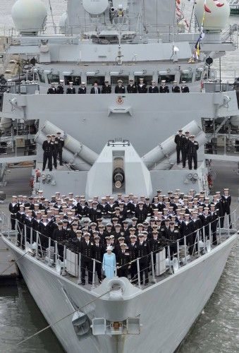 Britain's Queen Elizabeth poses for a photograph with the crew of HMS Lancaster in Portsmouth, southern England