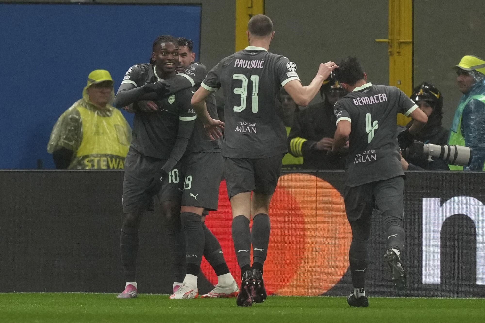 AC Milan's Rafael Leao, left, celebrates after scoring the opening goal during the Champions League opening phase soccer match between AC Milan and Girona at the San Siro stadium in Milan, Italy, Wednesday, Jan. 22, 2025. (AP Photo/Antonio Calanni). EDITORIAL USE ONLY/ONLY ITALY AND SPAIN