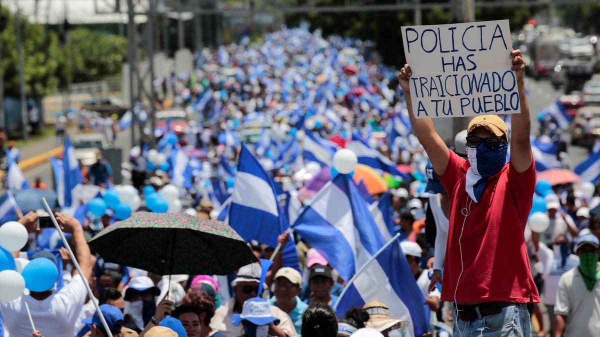 An anti-government protester holds a sign that reads &quot;Police have betrayed your people&quot; during a protest against Nicaraguan President Daniel Ortega's government in Managua