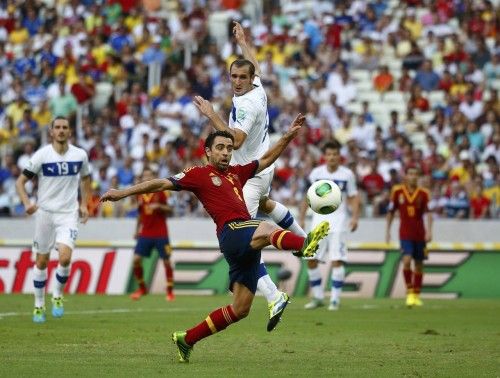 Spain's Xavi fights for the ball with Italy's Chiellini during their Confederations Cup semi-final soccer match at the Estadio Castelao in Fortaleza