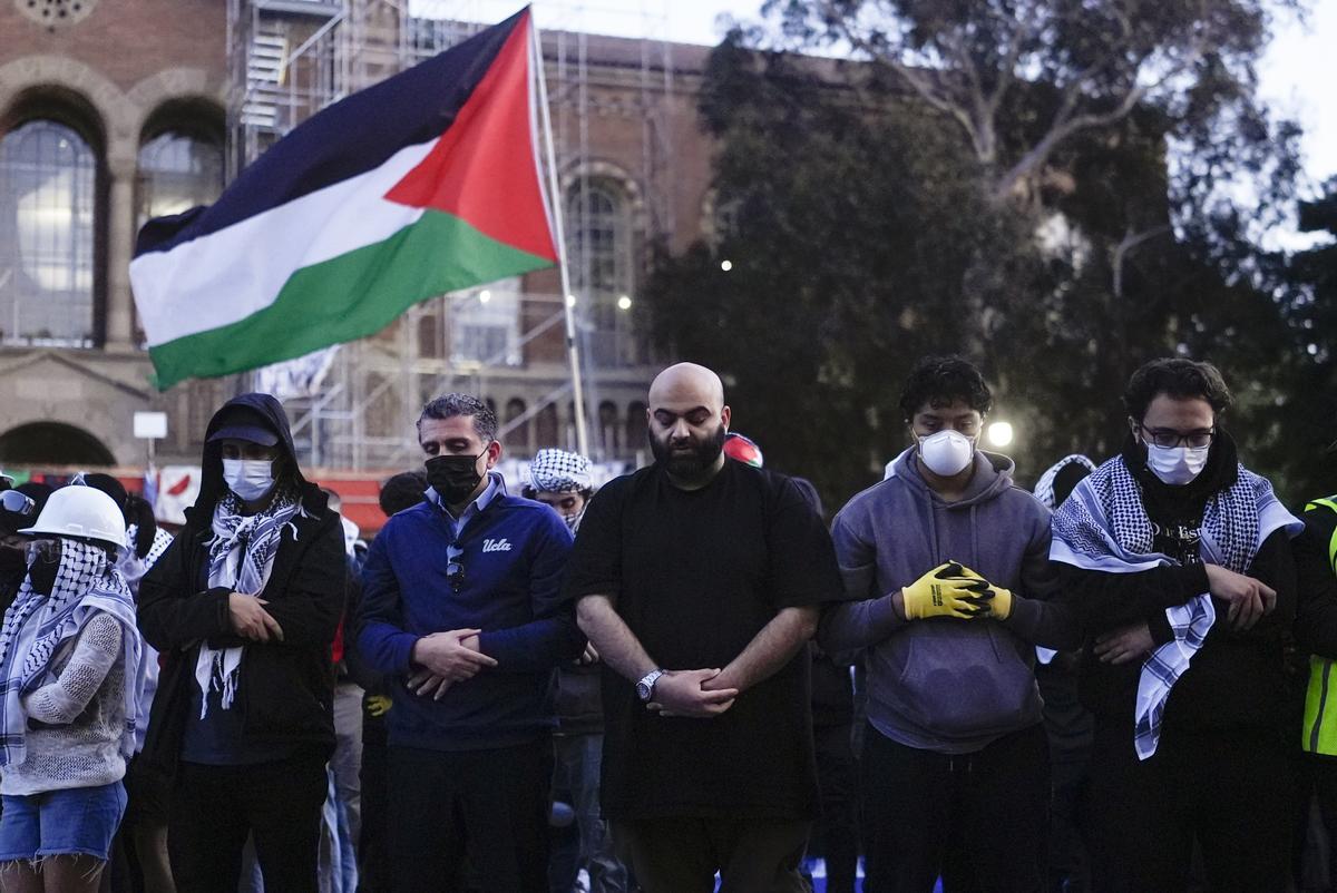 Pro-Palestinians protesters pray on the UCLA campus Wednesday, May 1, 2024, in Los Angeles. (AP Photo/Jae C. Hong)