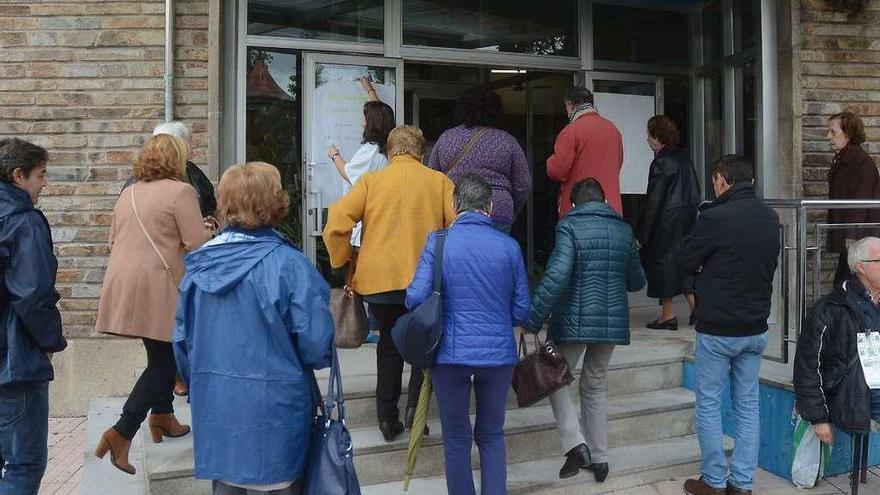 Momento en que una trabajadora retira un cartel de la entrada y permite el paso a los usuarios. // R. Vázquez