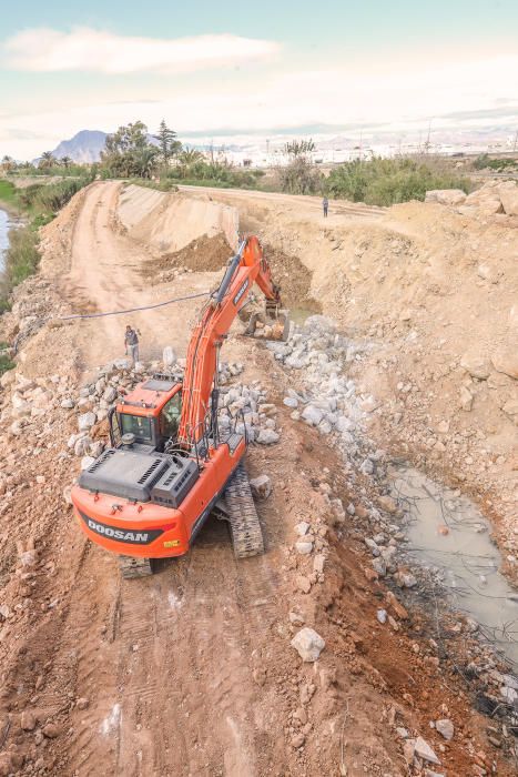 Obras de reparación de la CHS de la mota del río que cedió en Almoradí durante la DANA. Muchas de las zonas afectadas por el paso del agua siguen arrasadas