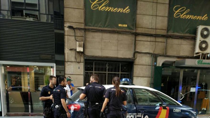 Los agentes introducen en el coche policial al detenido.