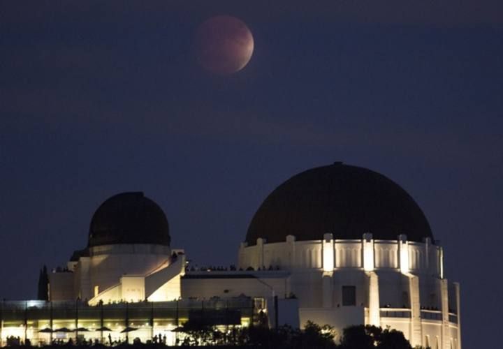 A supermoon is seen in the sky above Griffith Park Observatory in Los Angeles, California