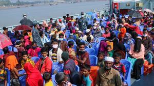 Rohingya refugees board a Bangladesh Navy ship to be transported to the island of Bhashan Char in Chittagong on December 4  2020  - Bangladesh began transferring hundreds of Rohingya refugees on Thursday to a low-lying island in an area prone to cyclones and floods  with rights groups alleging people were being coerced into leaving  (Photo by -   AFP)