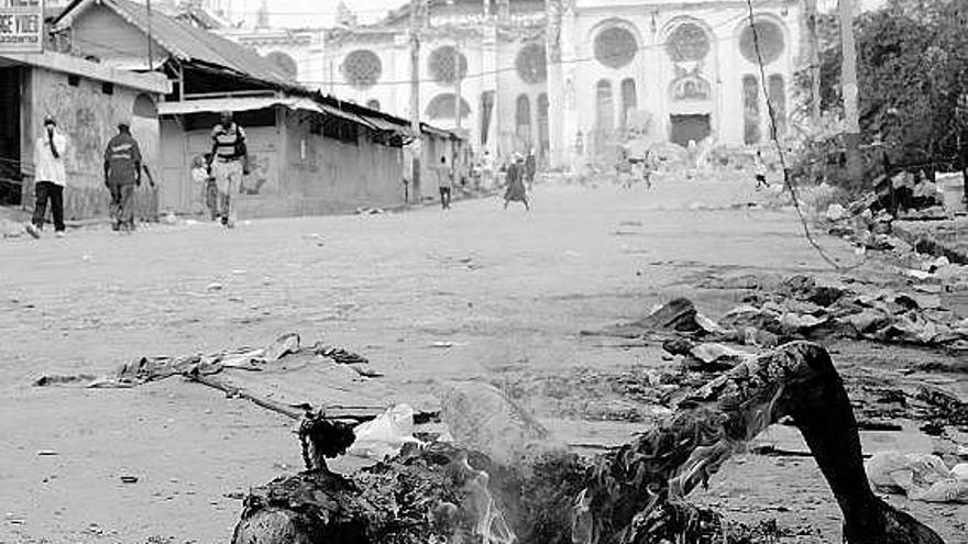 fuego purificador.  Una víctima del terremoto arde en las calles de Puerto Príncipe, donde el fuego ha sido la solución para desprenderse de los cadáveres acumulados.