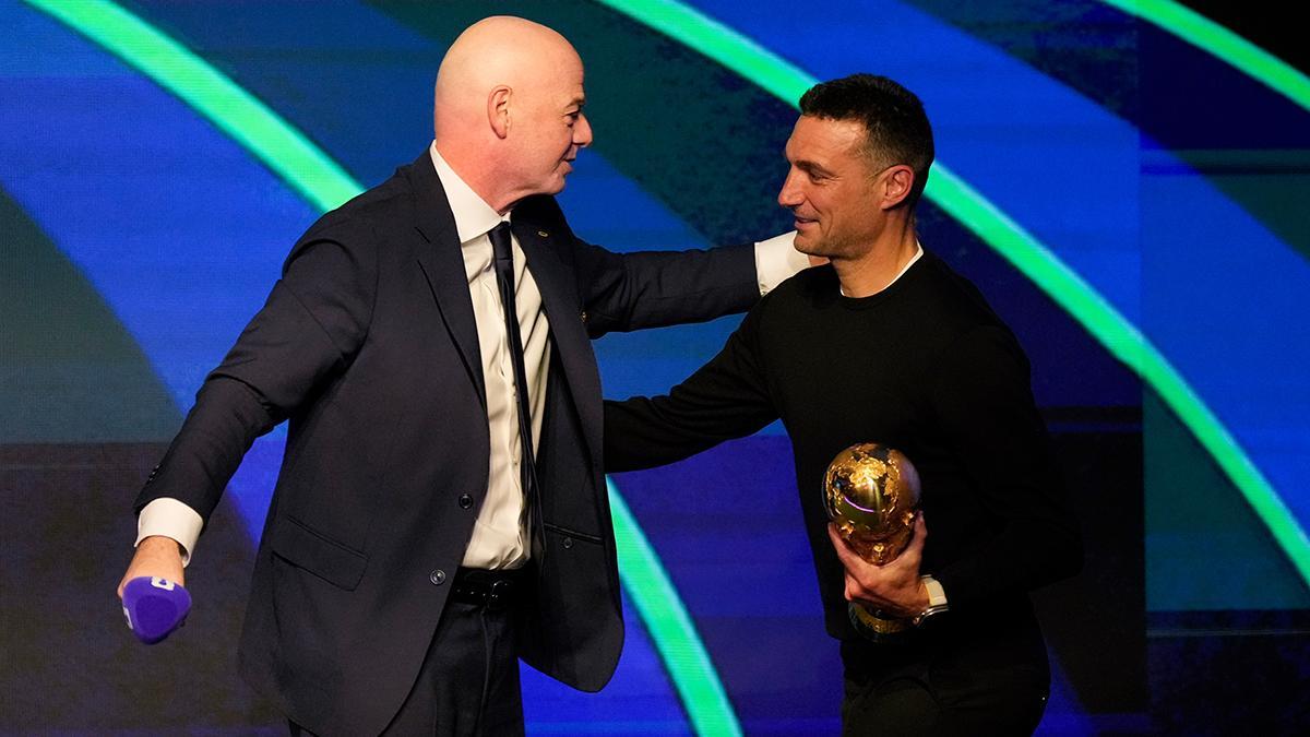 El presidente de la FIFA Gianni Infantino, saluda al seleccionador de Argentina, Lionel Scaloni, que lleva el trofeo de la Copa del Mundo