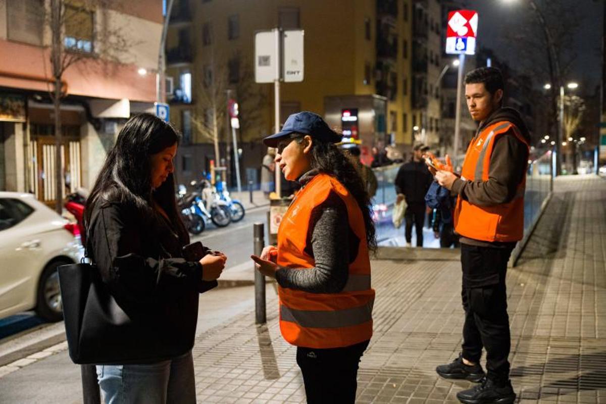 Los serenos de Esplugues reparten tarjetas con su teléfono de contacto a la entrada del metro de Can Vidalet