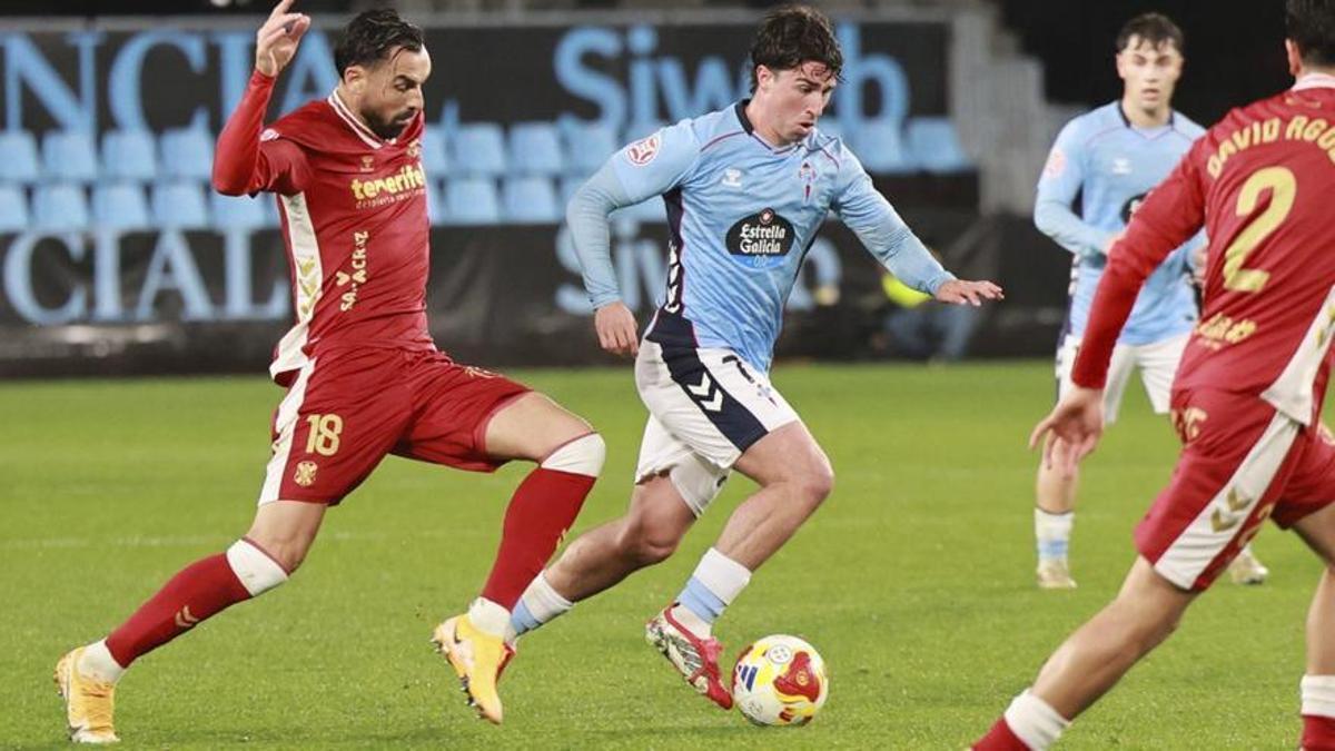 Hugo González conduce la pelota entre dos rivales durante la reciente visita del líder, Tenerife, al estadio de Balaídos. | JOSÉ LORES
