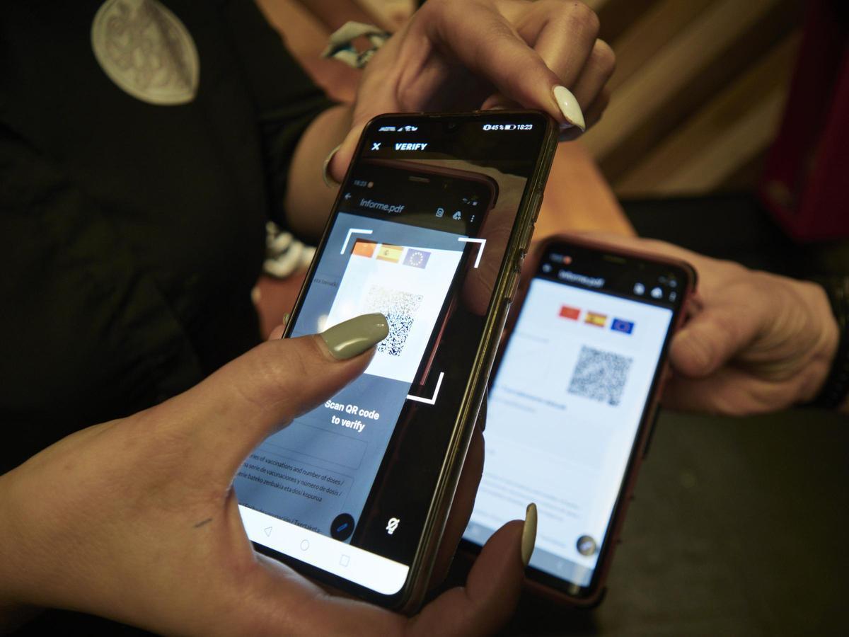 Una persona muestra su pasaporte Covid.