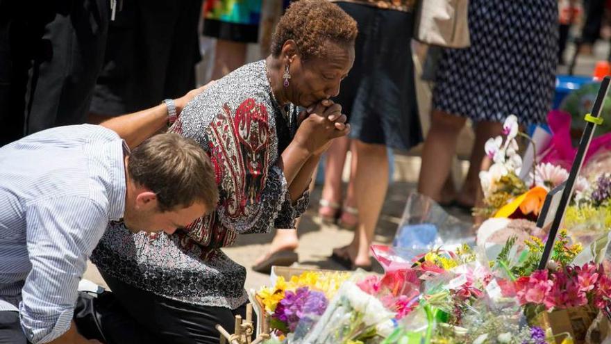 Dos personas rezan, ayer, minutos antes del oficio religioso en la iglesia metodista de Charleston.