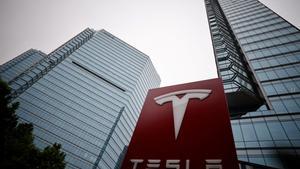 FILE PHOTO: A Tesla logo is seen outside a showroom of the carmaker in Beijing