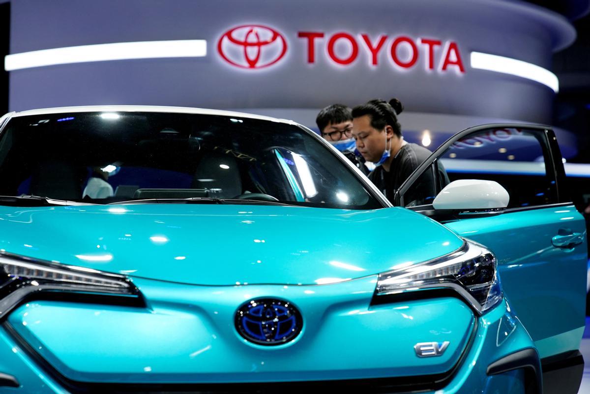 FILE PHOTO: Visitors check a Toyota vehicle during the Shanghai auto show