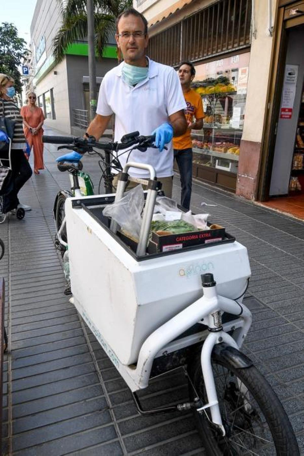 29-04-20  LAS PALMAS DE GRAN CANARIA. CIUDAD. LAS PALMAS DE GRAN CANARIA. Fotos del dia. Este señor reparte la compra a personas que tienen movilidad reducida llevandoles la compra  en el  vehiculo de su empresa llamada Apiñon, se ha tenido que reconvertir pasando de llevar a turistas de los cruceros al reparto. Fotos: Juan Castro.  | 29/04/2020 | Fotógrafo: Juan Carlos Castro