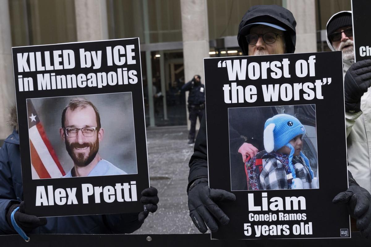 Protesters hold signs that read 'KILLED by ICE in Minneapolis Alex Pretti' with his picture 'Worst of the worst Liam Conejo Ramos 5 years old' with his picture in his bunny hat.