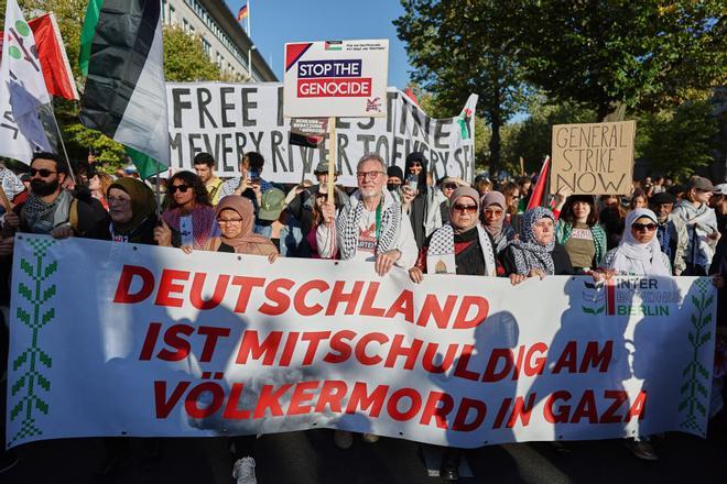 People hold a banner, reading Germany is complicit in the genocide in Gaza during a mass demonstration called All Eyes on Gaza in support of Palestinians in Berlin, Germany, Saturday, Sept. 27, 2025. (AP Photo/Christoph Soeder)