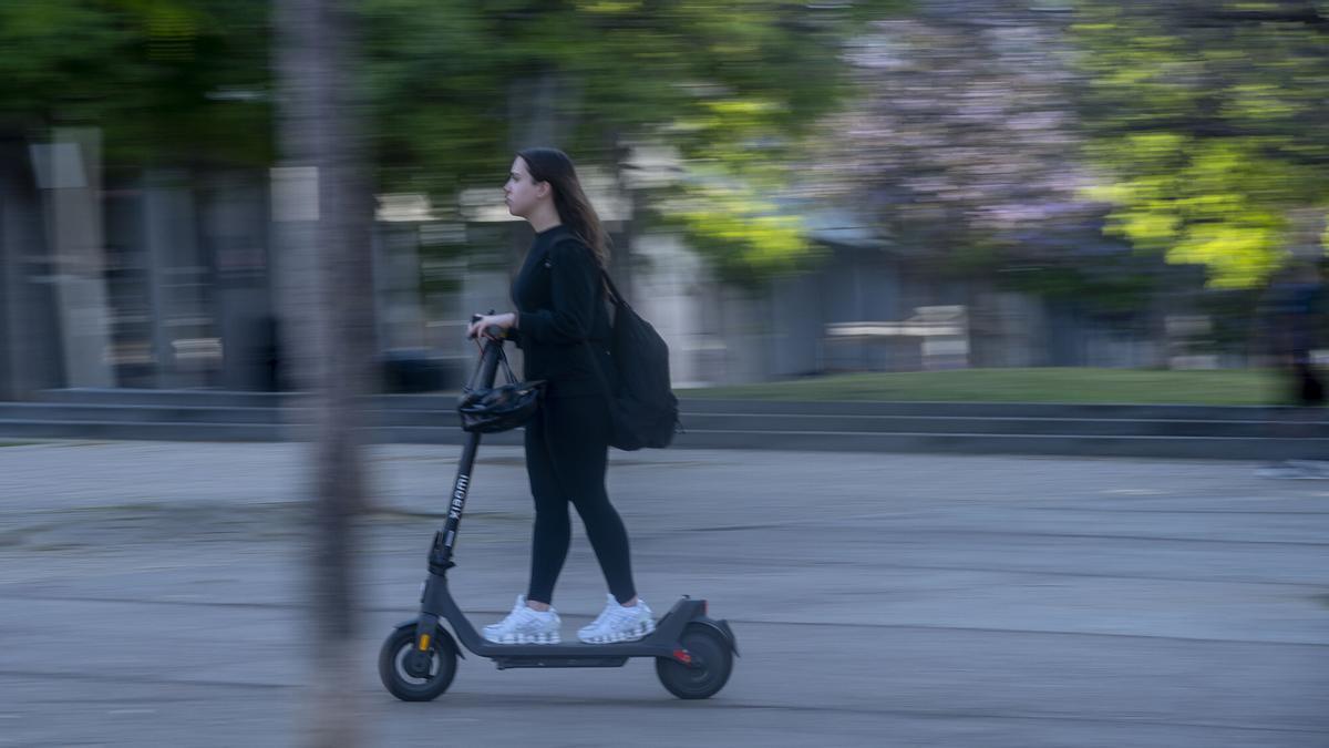 Un patinet circula per la plaça Mestres Maria Rosquellas i Joan Rotger a Badalona abans de la nova (i primera) regulació de circulació per a patinets elèctrics i altres VMP de la ciutat de Badalona.