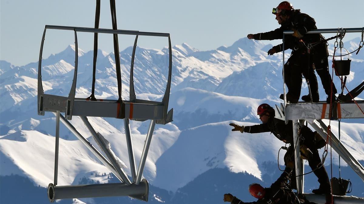 Varios técnicos intentan alcanzar una pieza de la estructura metálica durante la instalación de la plataforma en la cima del Pico de Midi, una de las montañas más altas de Francia, en Bagneres-de-Bigorre, el 30 de enero.