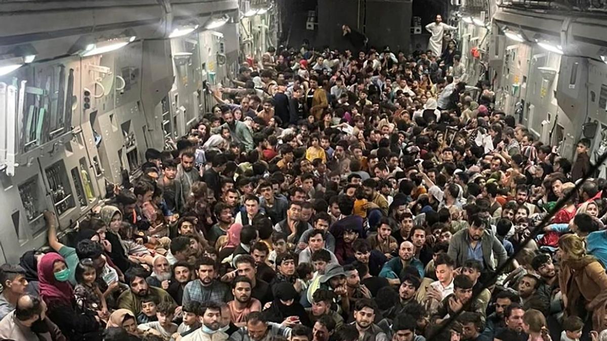 Evacuees crowd the interior of a U.S. Air Force C-17 Globemaster III transport aircraft departing Kabul