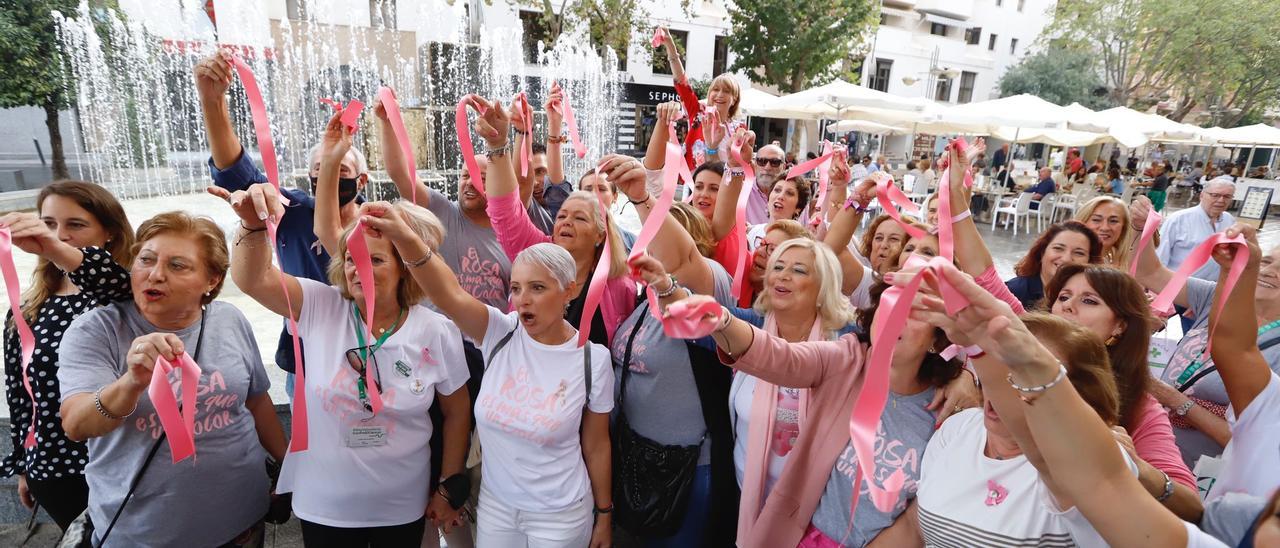Pacientes y voluntarias de la AECC en Córdoba alzan sus lazos rosa contra la existencia del cáncer de mama.