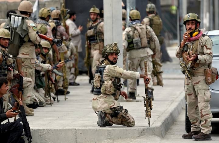 Members of Afghan security forces arrive at the site of an attack near the Afghan parliament in Kabul