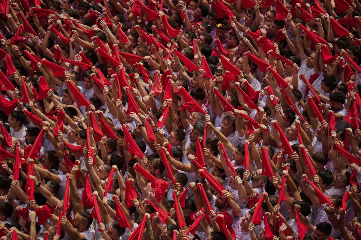 Revelers pack the main square during the start of nine days of uninterrupted partying in Pamplonas famed running-of-the-bulls festival in Pamplona, Spain, Sunday, July 6, 2025. (AP Photo/Miguel Oses). EDITORIAL USE ONLY/ONLY ITALY AND SPAIN
